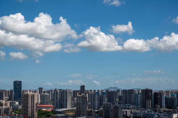 istock City architecture under clear blue sky and white clouds 2172096636
