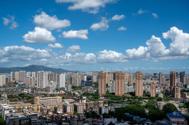 istock City architecture under clear blue sky and white clouds 2172096702