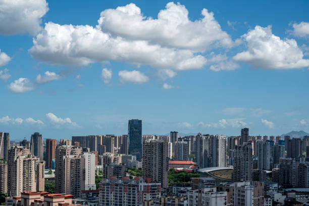 istock City architecture under clear blue sky and white clouds 2172096723