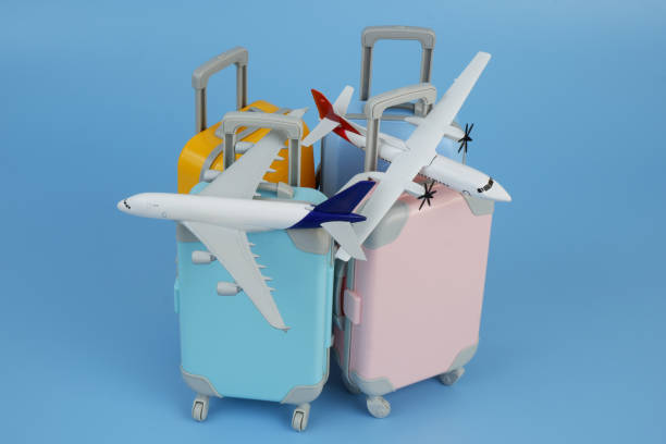istock Airplane models on several travel suitcases on blue background. 2172096964