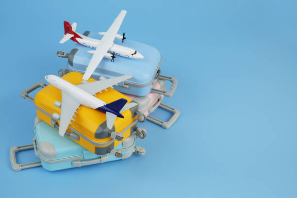 istock Airplane models on several travel suitcases on blue background. 2172097413