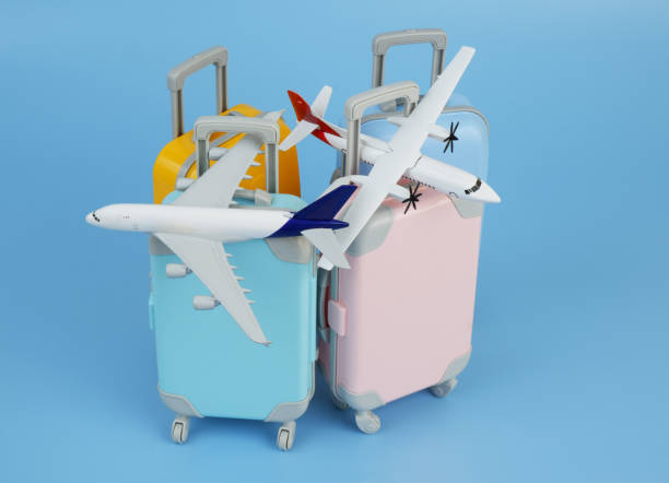 istock Airplane models on several travel suitcases on blue background. 2172097437