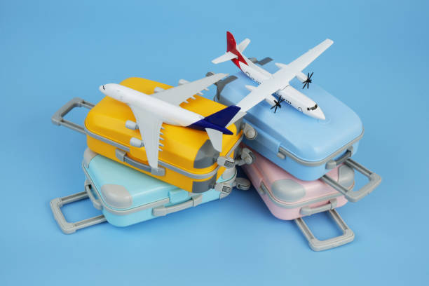 istock Airplane models on several travel suitcases on blue background. 2172097451