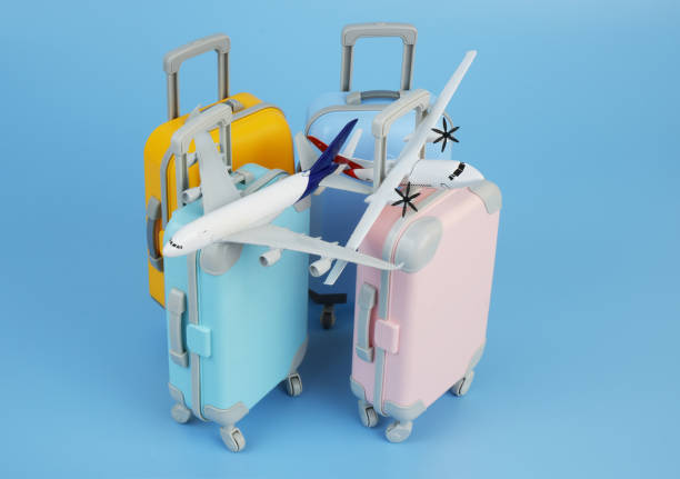 istock Airplane models on several travel suitcases on blue background. 2172097452