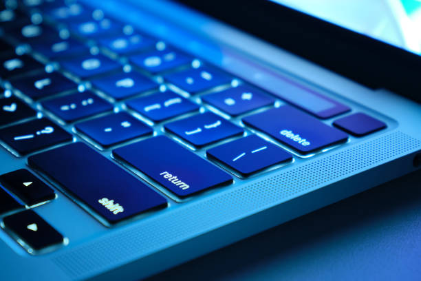 Close-up keyboard of a modern laptop  with beautiful backlighting. Using devices for work and leisure. Selective focus.