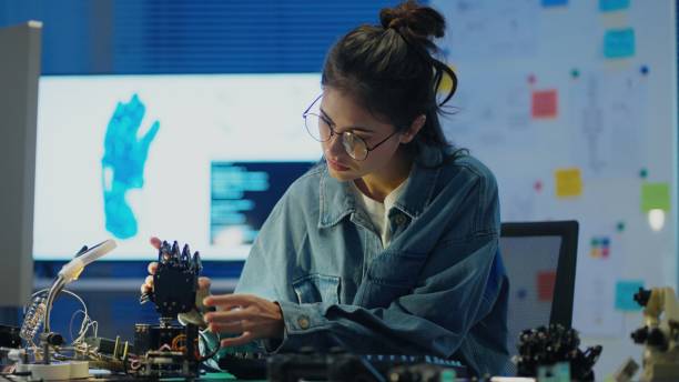 istock Female engineer shapes the future of robotics with AI-driven automation and Bluetooth control in laboratory room. 2172101007