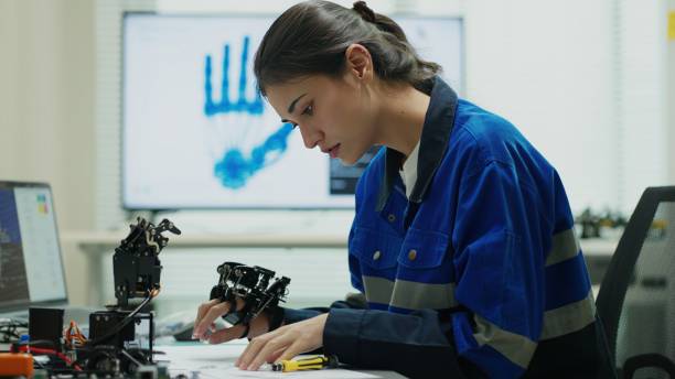 istock Engineer Perfects Robotic Arm assemblies in Futuristic Lab. 2172101049