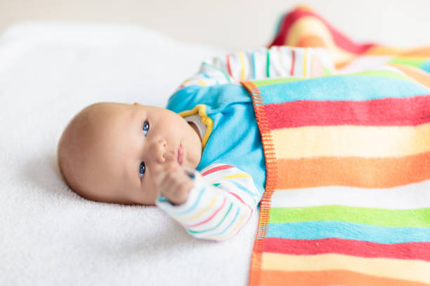 Baby Girl Sleep in Bed, Newborn Child Covered By Pink Knitted Blanket, Sleeping New Born Kid