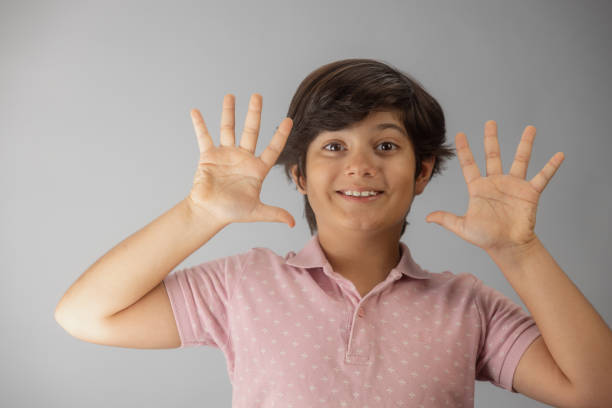 Young multiracial boy Indian-Iranian looking at camera making faces and gestures