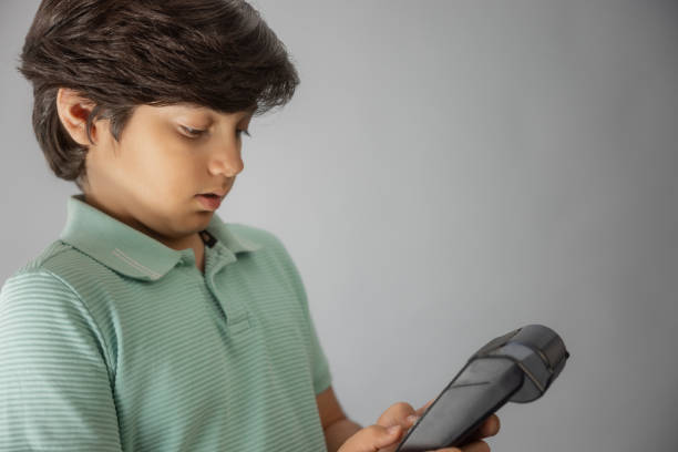 Young multiracial boy Indian-Iranian looking at camera, entering pin.