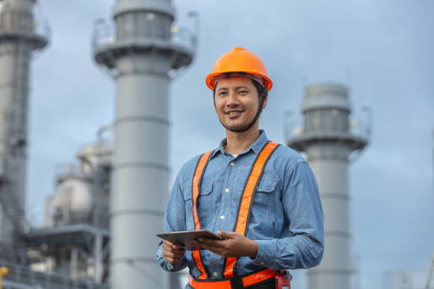 istock Man engineer with tablet working factory producing electricity oil energy. Construction manager oil refinery in petrochemical. improvement inspector Industrial worker working power plant. 2172102580