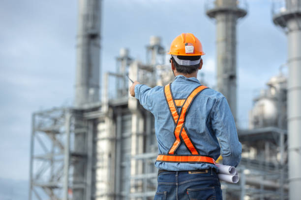 istock Asian worker power plant factory holding blueprint pointing check construction plan power plant. Engineer wearing safety uniform helmet at energy petrochemical industry. 2172102581