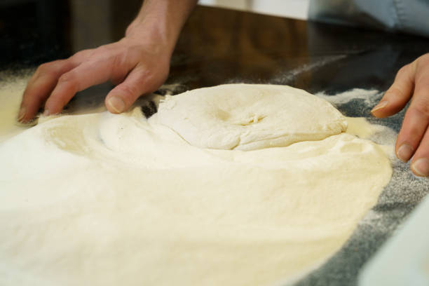 istock Making a pizza, close up of hands kneading the pizza dough 2172103731
