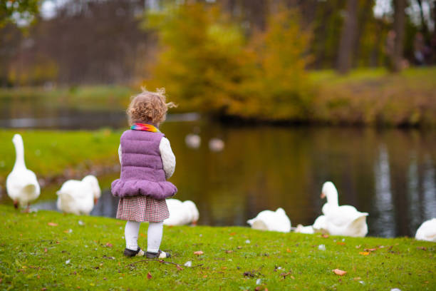 istock Kids playing in autumn park 2172103791