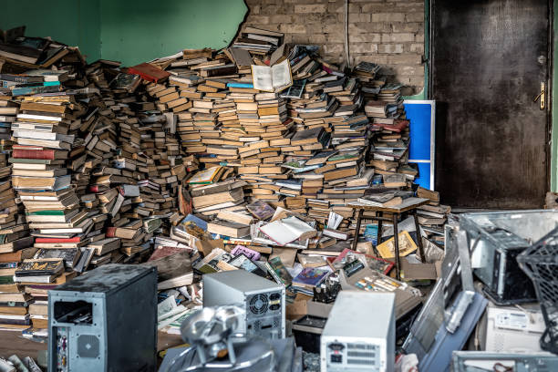 istock Dirty and abandoned office with books, papers and computers 2172103996