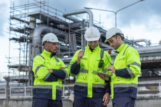 istock Team professional electrical engineer safety uniform working together at station refining oil petrochemical using tablet. Industrial factory site control energy power station. 2172104925