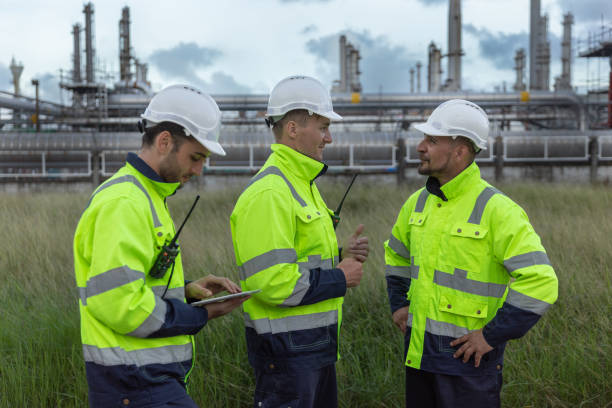 istock Team professional electrical engineer safety uniform working together at station refining oil petrochemical using tablet. Industrial factory site control energy power station. 2172104938
