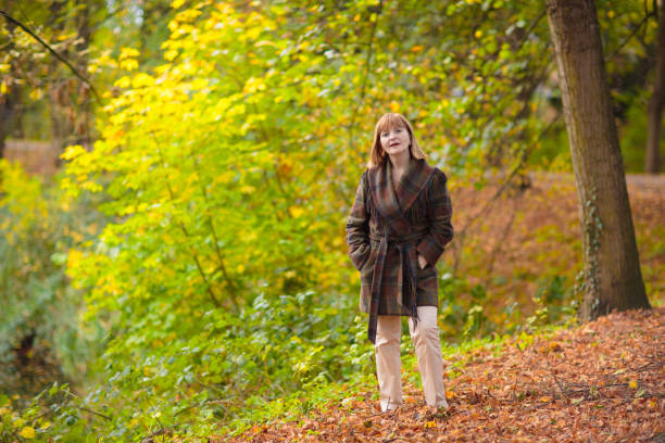 istock Beautiful woman in autumn park 2172104979
