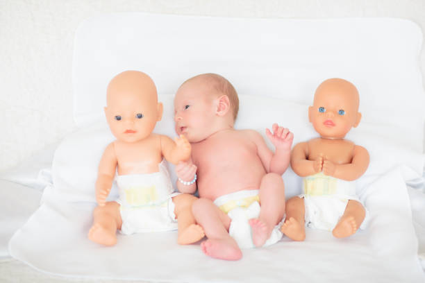 Toddler baby Girl playing Mother with her baby Doll