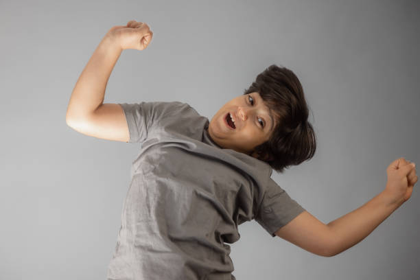 Young multiracial boy Indian-Iranian looking at camera jumping with joy
