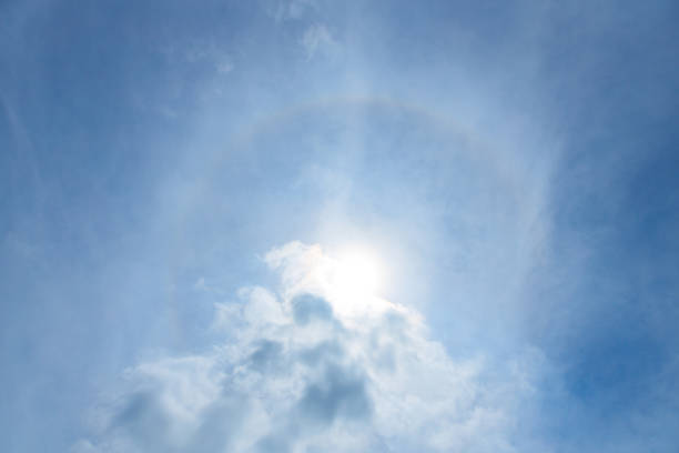 Scenic sunbeams through the clouds with circular rainbow in the blue sky, Cloudscape