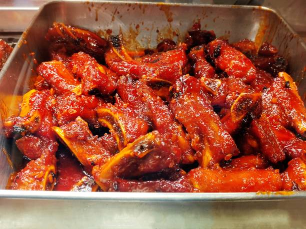 Close-up of a home style bbq smoked pork baby back ribs slided and piled high in a bowl ready to be eaten!