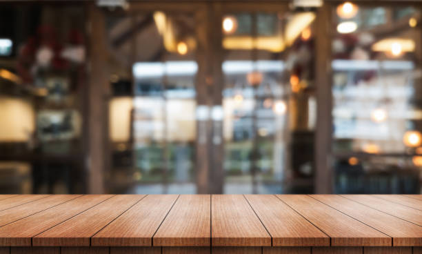 istock Empty wooden table top with lights bokeh on blur restaurant background. 2172120988