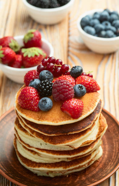 istock Stack of homemade american pancakes with berries . Top view 2172122562