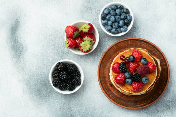 istock Stack of homemade american pancakes with berries . Top view 2172122589