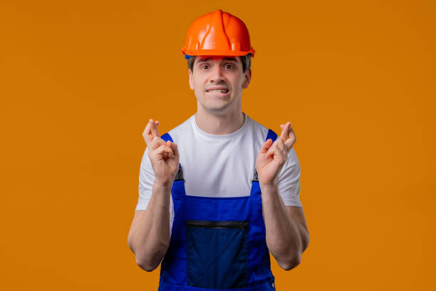 istock Mature construction builder man praying on orange studio. Hopeful Prayer, belief 2172124233