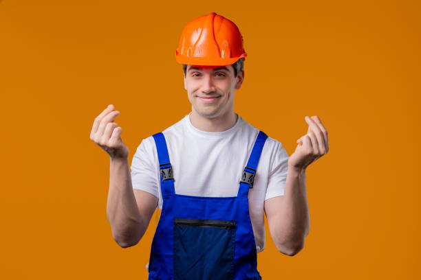 istock Smiling builder or handyman asking money on orange studio. Smart mature guy 2172124234