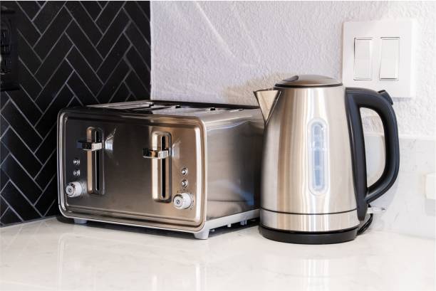 istock Modern stainless steel toaster and electric kettle on kitchen countertop. 2172127713
