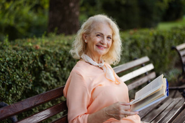 istock Senior Woman Relaxing With a Book Outside 2172129067