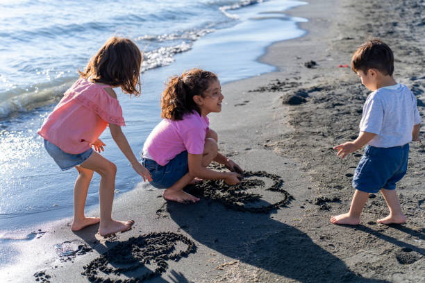 istock Children playing with sand by the sea. 2172134382