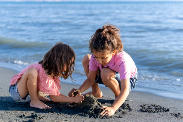 istock Children playing with sand by the sea. 2172134450
