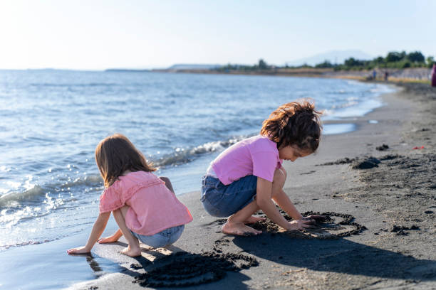istock Children playing with sand by the sea. 2172134457