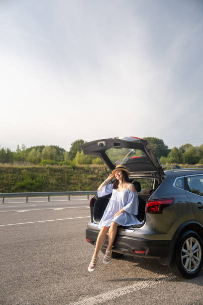 istock Woman Enjoying a Sunny Day by Her Car 2172137699