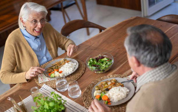 istock Elderly Couple Enjoying a Meal Together 2172137726