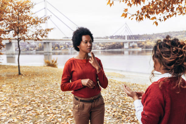 istock Female friends deaf talking with nonverbal communication outdoor. 2172138183