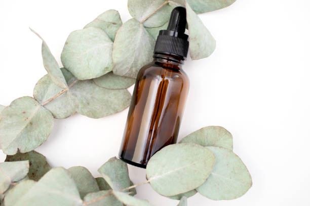 istock Essential oil bottle with a pipette and eucalyptus leaves 2172139384