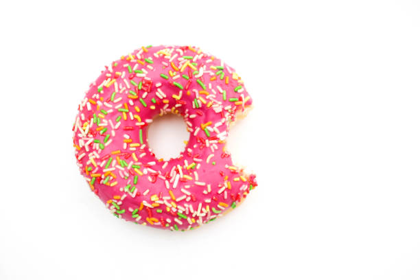 Bitten pink donut isolated on white background Bitten pink donut isolated on white background. doughnut stock pictures, royalty-free photos & images