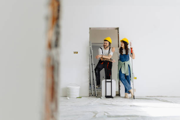 istock Young workers with painting tools indoors. Room renovation 2172142439