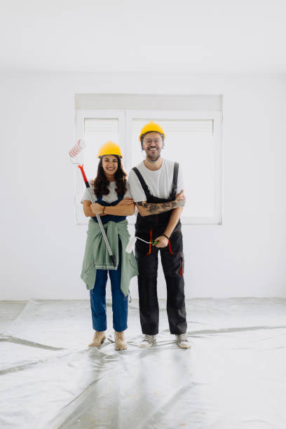 istock Young workers with painting tools indoors. Room renovation 2172142542