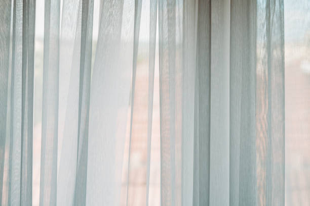 istock Bright light coming from the living room window through white curtains 2172146724