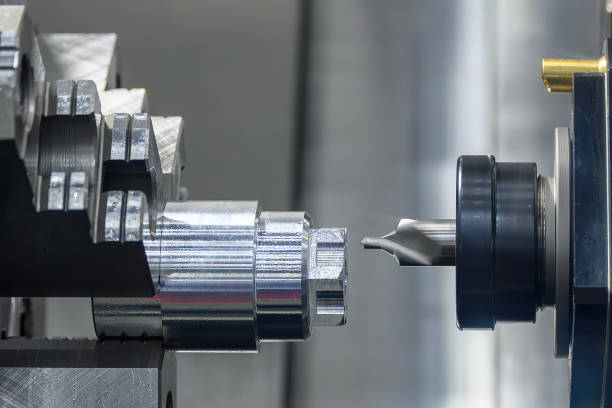The metal shaft chamfering process on CNC lathe machine in the light blue scene.