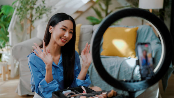 istock Young Asian woman applying makeup and giving techniques to audience while live streaming. 2172149939