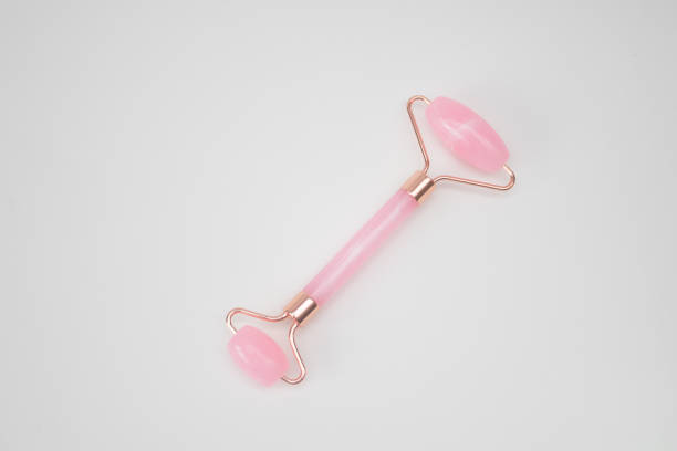 istock Roller Facial Massager pink quartz stone on white background 2172152284