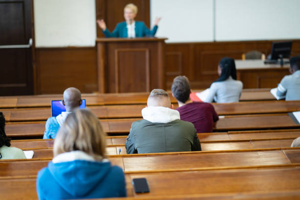 istock Rear view of students listening to a lecture 2172167988