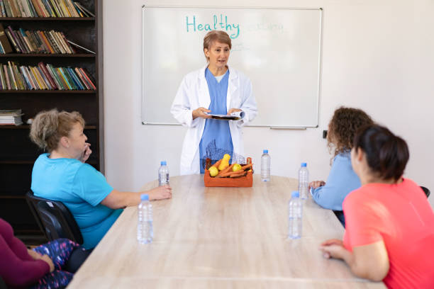 istock Dietitian presenting healthy foods to a group 2172168873