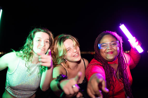 istock Women pointing while choreographing a song during beach night party 2172170307